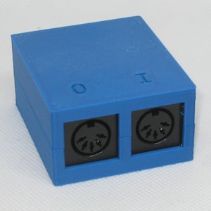 May include: A blue plastic box with two black MIDI connectors labeled "O" and "I".