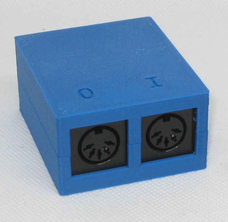 May include: A blue plastic box with two black MIDI connectors labeled "O" and "I".