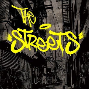 May include: A black and white illustration of a city alleyway with graffiti on the walls. The words "The Streets" are written in yellow spray paint on the wall. The text "Cool Colouring Graffiti Colouring Book" is written in yellow at the bottom of the image.