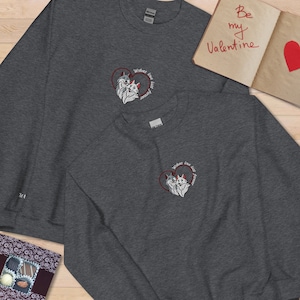 A pair of personalized embroidered sweatshirts for couples on Valentine&#39;s Day featuring a pair of wolves and a romantic quote. A Valentine&#39;s Day gift.