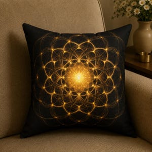 May include: Black square throw pillow with a golden, geometric design. The pattern features a central, bright, glowing circle with radiating lines and interconnected shapes. The pillow is on a beige chair.