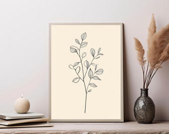 May include: A rectangular framed wall art print featuring a black line drawing of a single botanical branch with multiple oval-shaped leaves centered on a solid cream-colored background. The frame is a light neutral tone with a thin border profile.