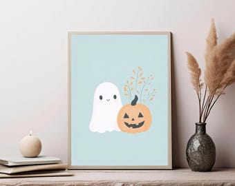 May include: A rectangular framed wall art print featuring a light blue background with a white ghost character and an orange jack-o'-lantern pumpkin. The pumpkin has a black carved face and thin, delicate orange sprigs extending from the top.