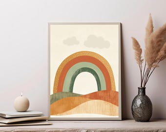 May include: A framed wall art print featuring a stylized rainbow with bands of orange, green, and yellow, set against a cream background with two soft clouds. The bottom of the print displays layered, textured hills in shades of orange and green.
