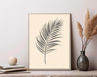 May include: A rectangular framed wall art print featuring a black line drawing of a single palm leaf centered on a solid light beige background. The artwork is enclosed in a thin, light-colored frame, presenting a clear botanical illustration.