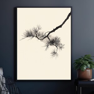 May include: A framed wall art print featuring a black ink illustration of a pine tree branch with needle clusters on a solid cream-colored background. The artwork is enclosed in a thin black frame, showcasing a high-contrast botanical design.