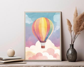 May include: A framed wall art print featuring a watercolor illustration of a multi-colored hot air balloon with vertical stripes in yellow, orange, pink, and blue, floating above a dense layer of soft, fluffy pink and white clouds in a sky.