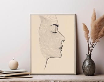 May include: A rectangular framed wall art print featuring a black line drawing of a human face in profile. The portrait is composed of numerous fine, flowing contour lines against a solid, light beige background, creating a topographic effect.
