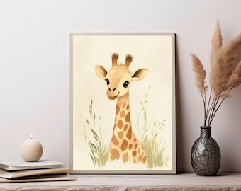 May include: A framed wall art print featuring a watercolor illustration of a young giraffe with large dark eyes and brown spots on a cream background, surrounded by light green blades of grass, presented in a simple light-colored frame.
