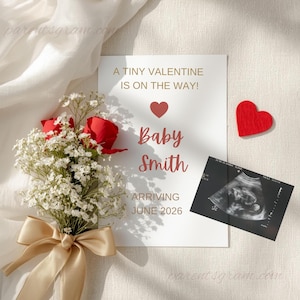 May include: A pregnancy announcement card with the text "A TINY VALENTINE IS ON THE WAY!" and "Baby Smith ARRIVING JUNE 2026". The card is next to a sonogram, a red heart, and a bouquet of red roses and white flowers.