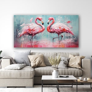 May include: A painting of two pink flamingos standing in a shallow body of water. The flamingos are facing each other and their necks are curved in a heart shape. The background is a light blue with splashes of pink and white paint.