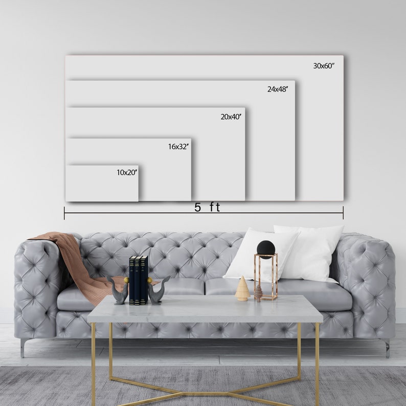 May include: A visual representation of different canvas print sizes, ranging from 10x20 inches to 30x60 inches. The sizes are displayed on a white wall with a gray couch and a coffee table in the foreground.