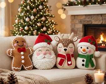 May include: Four crochet cushions shaped like festive characters: a brown gingerbread person, a Santa Claus with a red hat, a tan reindeer with a red scarf, and a white snowman wearing a red hat and green scarf, all featuring embroidered details.
