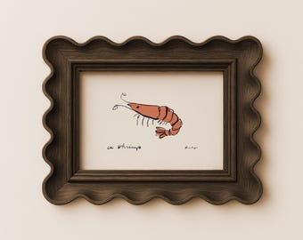 May include: A framed art print featuring a stylized illustration of a pink shrimp on a cream background. The text "a shrimp" is written in black ink below the shrimp. The frame is dark brown with a wavy, scalloped edge and a wood grain texture.