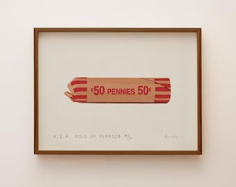 May include: A framed print featuring a tan paper roll of pennies with red stripes and the text 50 PENNIES 50c. Below the roll, the text reads R.I.P. ROLL OF PENNIES 11/25, accompanied by a handwritten signature in the bottom right corner.