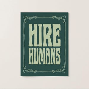 A green on green art print of the words HIRE HUMANS in a hand-lettered art nouveau style within a decorative art nouveau border.
