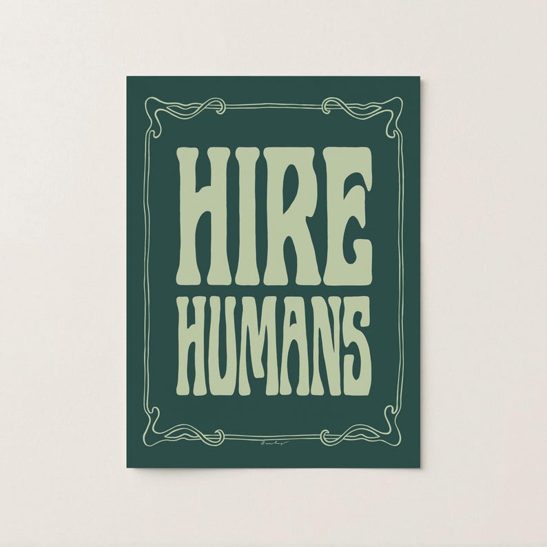 A green on green art print of the words HIRE HUMANS in a hand-lettered art nouveau style within a decorative art nouveau border.