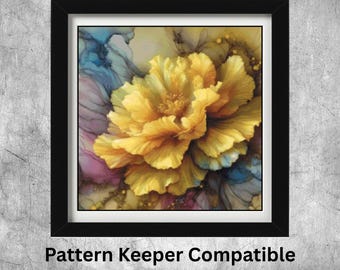 May include: A framed print featuring a vibrant yellow flower with detailed petals. The artwork has a watercolor effect with blue and pink hues in the background. The frame is black, and the text "Pattern Keeper Compatible" is at the bottom.