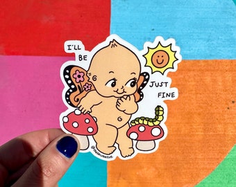May include: A sticker featuring a cartoon baby with butterfly wings, standing on a mushroom with a worm. The baby is smiling and has the text "I'll be just fine" above it. The sticker is on a colorful background.