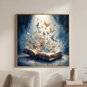 May include: A watercolour painting in a gold frame, depicting an open book with butterflies and birds flying out. The background is a soft blue and white, creating a whimsical effect. The image is square and evokes a sense of fantasy and art.