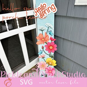 May include: A blue and white wooden porch leaner with the text "Hello Spring" in red. The leaner is decorated with pink, orange, and yellow flowers and butterflies.