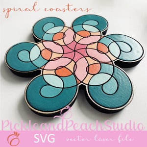 May include: A set of six teal, pink, and orange spiral coasters in the shape of a flower. The coasters are made of wood and have a laser-cut design. The text "spiral coasters" is at the top of the image and the text "Pickle and Peach Studio SVG vector laser file" is at the bottom of the image.