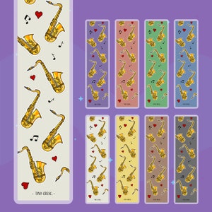May include: A set of 10 printable bookmarks featuring a gold saxophone with red hearts and musical notes on different coloured backgrounds. The text "TINY CRESC." is on each bookmark.