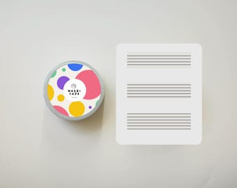 May include: A roll of colorful washi tape with a white background and a circle logo that says "WASHI TAPE" in black text. The tape is in a clear plastic container.