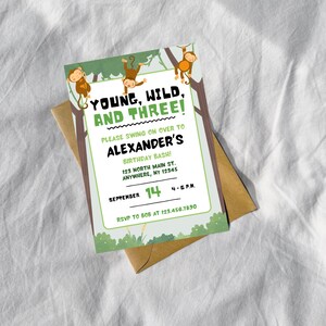 May include: A birthday invitation with a jungle theme. The invitation features the text "Young, Wild, and Three!" with monkey illustrations. The invitation is on a white background and includes the date, time, and location of the birthday party.