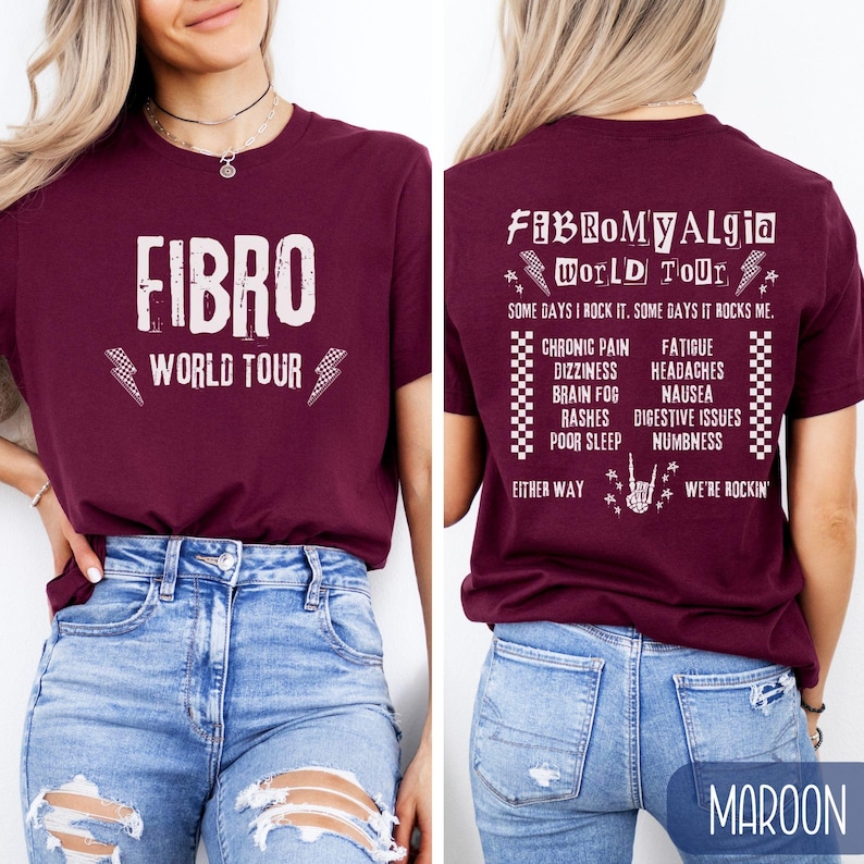 May include: Maroon t-shirt with the text "FIBRO World Tour" on the front and "Fibromyalgia World Tour" on the back. The back also lists symptoms of fibromyalgia, including chronic pain, fatigue, dizziness, headaches, brain fog, nausea, rashes, digestive issues, poor sleep, and numbness. The text on the back also says "Some days I rock it. Some days it rocks me." and "Either way, we're rockin'."