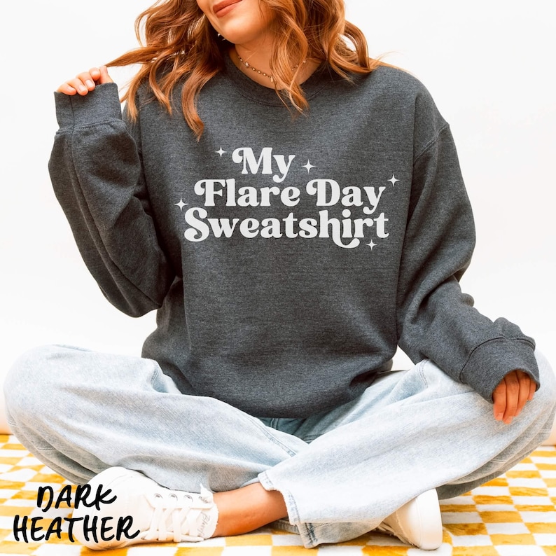 May include: Dark heather gray sweatshirt with the text "My Flare Day Sweatshirt" in white. The sweatshirt is a crew neck style. The words "Dark Heather" are printed at the bottom of the image.