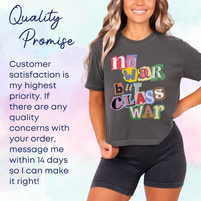 May include: A dark gray t-shirt with the text "no WAR but CLASS WAR" in colorful, cut-out style letters. The shirt is paired with black striped shorts. The image also includes text about customer satisfaction.