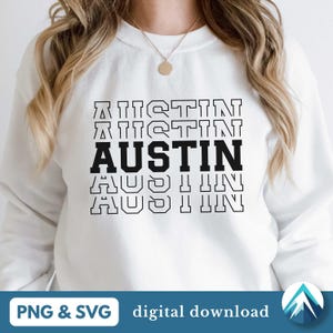 Puede incluir: Sudadera blanca con texto negro que dice "AUSTIN" repetido cuatro veces, cada repetición más pequeña. El texto está en una fuente retro y en bloques.