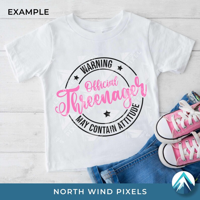 K&ouml;nnte beinhalten: Wei&szlig;es T-Shirt mit Rundhalsausschnitt und einem rosa-schwarzen Aufdruck mit der Aufschrift "WARNING Official Threenager MAY CONTAIN ATTITUDE". Das Shirt wird mit blauen Jeans und rosa Turnschuhen gezeigt.