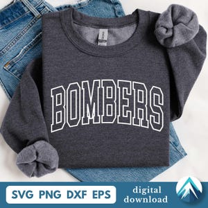 May include: A dark gray sweatshirt with the word "BOMBERS" in white, block letters. The sweatshirt is folded on top of blue denim jeans. The sleeves are cuffed. The bottom of the image has the text "SVG PNG DXF EPS" and "digital download".