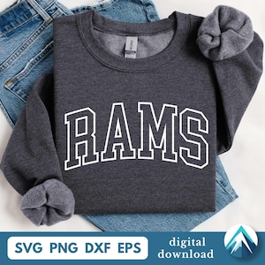 May include: A dark gray sweatshirt with the word "RAMS" in large white block letters. The sweatshirt is folded on top of blue denim jeans. The bottom of the image includes the text "SVG PNG DXF EPS" and "digital download".