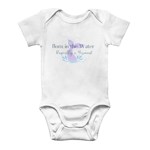 May include: White baby onesie with a purple mermaid tail and the text "Born in the Water Basically a Mermaid".