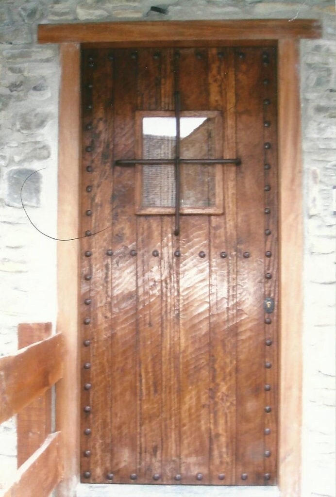 Medieval rustic door with large window