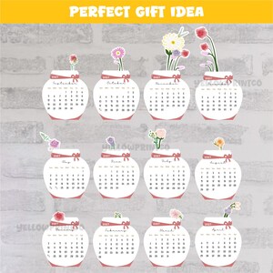 May include: A 2027 wall calendar featuring twelve white jar-shaped monthly pages, each decorated with a unique watercolor flower illustration at the top, a red ribbon graphic, and the text PERFECT GIFT IDEA at the top of the display.