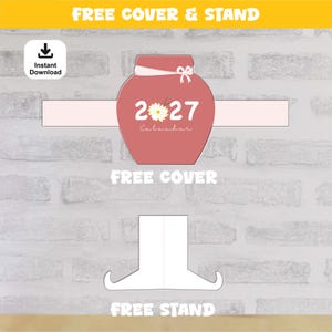 May include: A printable 2027 calendar cover in a dusty rose color with a white daisy graphic replacing the zero, featuring a white ribbon detail and the text 2027 Calendar, accompanied by a separate white paper stand template for assembly.