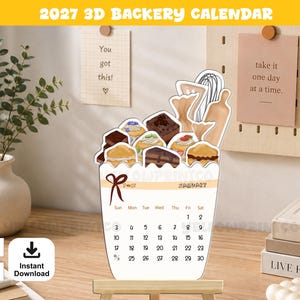Può includere: Un calendario 3D da panetteria per il 2027 con una parte superiore fustellata che mostra illustrazioni di vari pasticcini, una frusta e un mattarello. La base mostra il mese di gennaio con una griglia di date, un fiocco rosso e l'anno 2027.