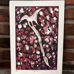 May include: Abstract art print titled "Crazy Evil" featuring a white, stylized weapon shape against a background of red, white, and black splatters. The artwork is signed and dated 2019.