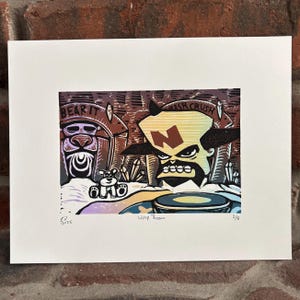 May include: A framed print featuring a colorful, stylized illustration with the words "BEAR IT" and "CRASH CRUSH". The artwork depicts a bear-like figure, a character with an "N" on its forehead, and a small creature. The print is signed and numbered.
