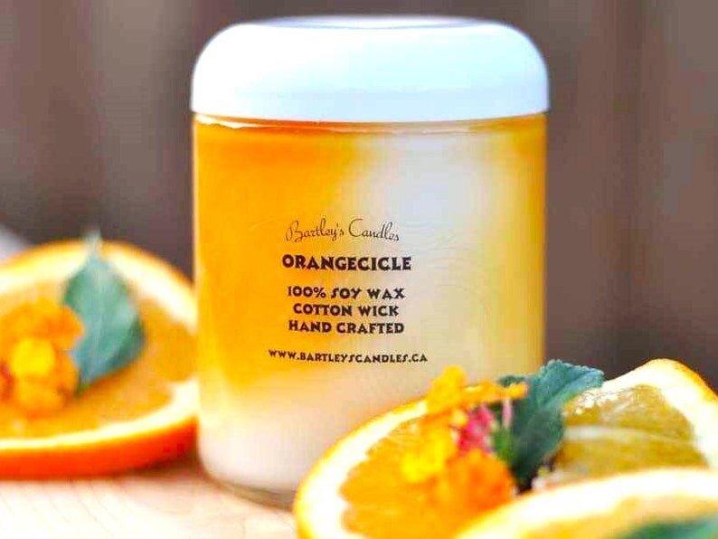 one hundred percent soy wax, hand crafted, cotton wick, eight ounce, orange scented candle.