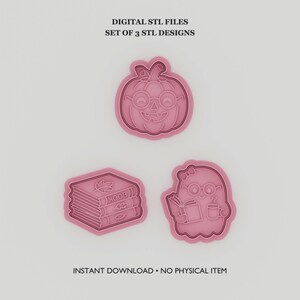 Può includere: Un set di tre stampini per biscotti rosa raffiguranti una zucca con occhiali, una pila di tre libri con foglie e un fantasma con occhiali che tiene un libro e una tazza. Testo: DIGITAL STL FILES SET OF 3 STL DESIGNS INSTANT DOWNLOAD.