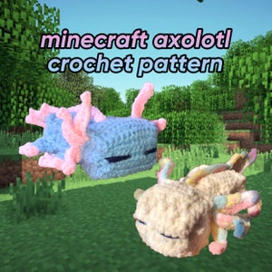 May include: Two crocheted Minecraft axolotl plushies. One is light blue with pink gills and the other is cream with rainbow gills. The plushies are sitting on a green grassy surface with a Minecraft background.