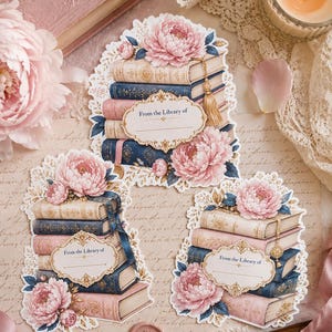 May include: Three die-cut bookplates featuring stacks of vintage-style books in shades of blue, cream, and pink, adorned with pink peony illustrations and gold tassels. Each label includes the printed text From the Library of with a line.