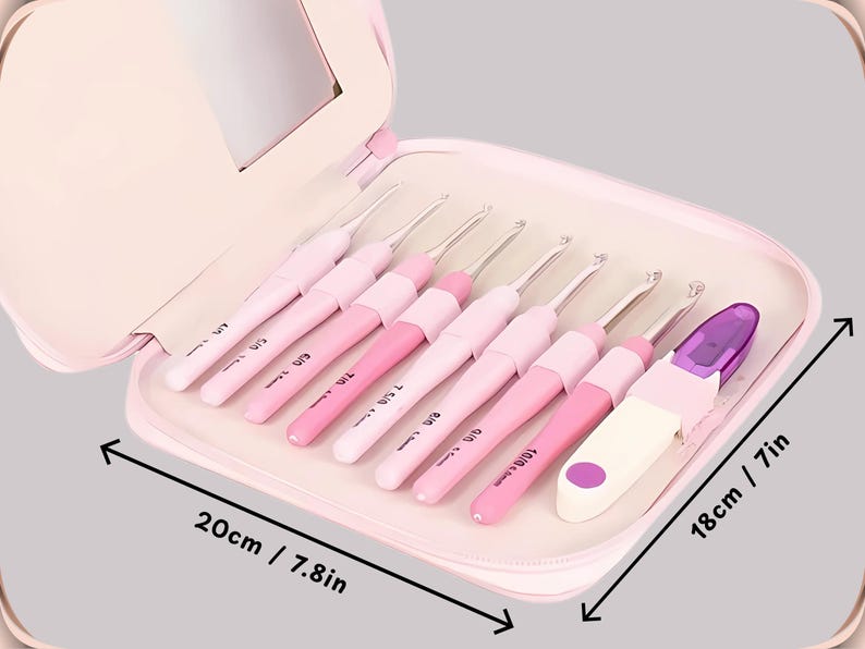 May include: A set of pink crochet hooks in a matching case. The case is open, displaying several crochet hooks in different shades of pink. The case measures 20cm wide and 18cm tall.