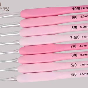 May include: A collection of eight crochet hooks with pink handles and silver hooks. Sizes range from 2.5mm to 6.0mm, each labelled with its size. The handles are in varying shades of pink.
