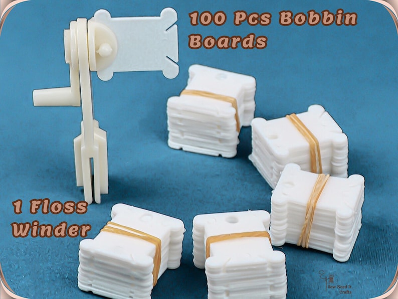 May include: A white floss winder and 100 white bobbin boards, secured with tan bands, are shown against a blue backdrop. Text reads "100 Pcs Bobbin Boards" and "1 Floss Winder". Suitable for organising embroidery floss.